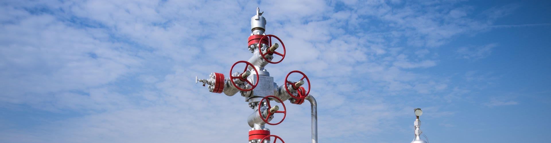 Red and white wheeled metal pole under clear sky