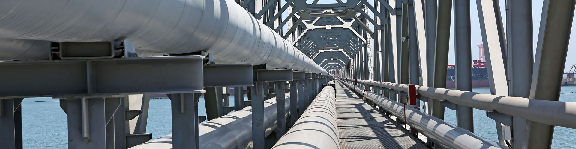 A metal rail on a large pipe